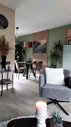 a living room filled with furniture and a clock on the wall