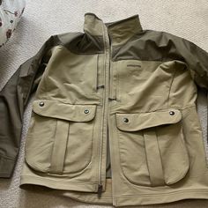 Light Tan/Dark Tan Men's Size L Jacket. Back Pocket With Zippers On Both Sides And Accessible From The Inside By Velcro. Front Full Length Zipper With Big Side Pockets (Both L & R Sides) And Zipper Pockets On Top Front (Both L & R Sides). Never Been Worn. Nwot. Patagonia Brown Outerwear For Outdoor Activities, Midweight Outerwear With Pockets For Hiking, Midweight Hiking Outerwear With Pockets, Gore-tex Long Sleeve Outerwear For Outdoor Work, Gore-tex Outdoor Outerwear With Pockets, Patagonia Outerwear For Hiking, Vintage Windbreaker Jacket, Purple Vests, Mens Down Jacket