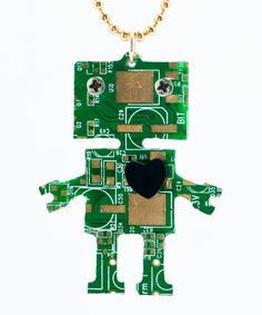 a green robot shaped key chain with a black heart