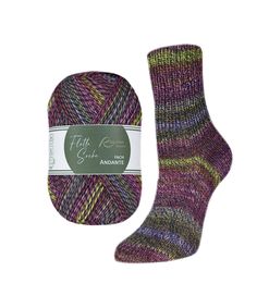 a purple and green sock with a tag on the side, next to it is a ball of yarn