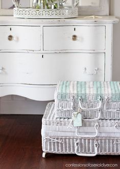 a wicker basket sitting on top of a wooden floor next to a white dresser