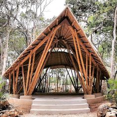 a wooden structure in the middle of some trees