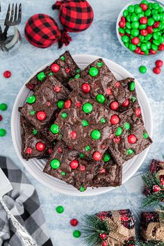 a white plate topped with brownies covered in candy