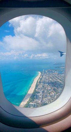 an airplane window looking out at the ocean