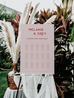 a table plan sitting on top of a lush green grass covered field next to tall plants