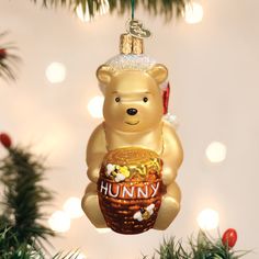 a christmas ornament shaped like a teddy bear with a basket of candy on it