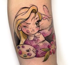 a woman's leg with a cartoon character tattoo on the side of her body