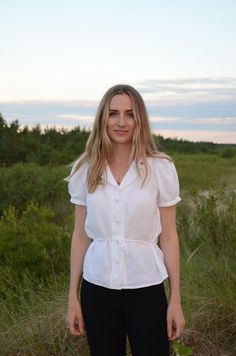 Our white blouse is one of our best-sellers - timeless design, style, and comfort - all in one. But we were still searching for some new additions (and cuteness). And here it is. A sleeveless white button-up shirt with a classic V-front, puffy sleeves, and a sophisticated collar, perfect for any season. We've added a little heart embroidery on the collar and a versatile linen belt to better match our different bodies. You can wear the belt at the back or at the front. Don't want the belt? Write Elegant Belted Summer Top, Elegant Belted Top For Summer, Elegant Summer Belted Top, Linen Belt, Short Puffy Sleeves, Collar For Women, Shirt With Collar, Linen Shirts Women, Heart Embroidery