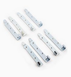 an assortment of white plastic door handles and latches on a white background with clippings