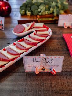 a table topped with slices of meat and veggies on top of wooden cutting boards