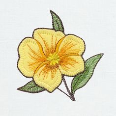 a yellow flower with green leaves is embroidered onto a white fabric material, which has been stitched together