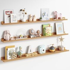 three wooden shelves filled with toys and books