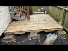 a wooden deck is being built on the side of a house