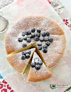 a cake with blueberries and powdered sugar on top