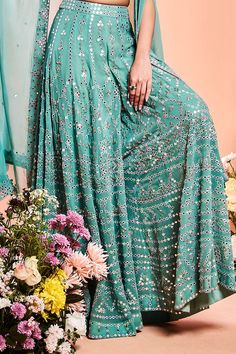 Aqua blue resham embroidered cape in foil mirror work. Paired with resham embroidered sharara and blouse.
Component: 3
Pattern: Hand embroidered
Type Of Work: Resham work, Foil mirror work
Neckline: Sweetheart
Sleeve Type: Sleeveless
Fabric: Organza, Georgette
Color: Blue
Other Details: 
Geometric motifs
Occasion: Wedding, Reception - Aza Fashions Designer Turquoise Sharara For Festive Occasions, Turquoise Semi-stitched Sharara For Festive Occasions, Elegant Turquoise Festive Set, Festive Turquoise Sharara With Resham Embroidery, Turquoise Semi-stitched Sharara With Dupatta, Festive Turquoise Sharara With Zari Work, Turquoise Bollywood Sharara For Designer Wear, Bollywood Style Turquoise Sharara For Designer Wear, Turquoise Sharara For Wedding