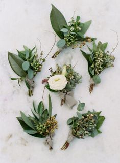 flowers and greenery laid out on a marble surface