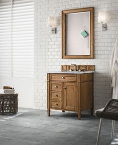 a bathroom with a sink, mirror and towel rack