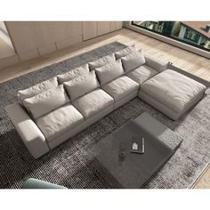 a large gray sectional sofa sitting on top of a rug