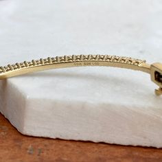 Estate 10KT yellow gold prong-set diamond bangle bracelet. A beautiful, staple diamond bangle! Also available in white gold. Push-in clasp with safety latch Measures: 2.3mm width at widest point 7” length Shown on a 6" wrist SI/I clarity, I-J color 1.00 carat lab-created diamonds Stamped 10KT and hallmarked Weight: 9.60 grams Anniversary Yellow Gold Diamond Bracelet With Prong Setting, Anniversary Yellow Gold Cuff Bracelet With Diamond Accents, Stackable Diamond Bracelet For Anniversary, 14k Gold Bangle Bracelet With Prong Setting, Fine Jewelry Bangle With Prong Setting For Anniversary, Modern Diamond Bangle Bracelet With Prong Setting, Anniversary Yellow Gold Cuff Bracelet With Brilliant Cut, Gold Bangle With Prong Setting For Anniversary, Modern Gold Bracelet With Prong Setting