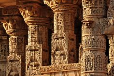 an intricately carved wall with columns and carvings