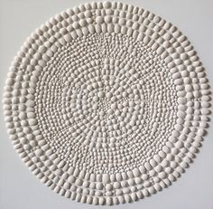 a white circular design made out of pebbles