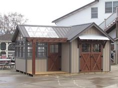 a small building with two doors and a porch