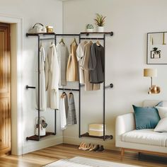 a living room with a white couch and coat rack