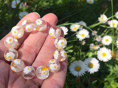 Lovely cute vintage Murano millefiori beads from an uncirculated stock in Venice. These vintage Venetian millefiori beads are great for collectors and for jewelry makers! These daisy beads are so sweet! ✔️Shape: round ✔️Finish: shiny ✔️Color: cristal clear glass with white and yellow daisies ;) ✔️Size: ca 12 mm. These beads are handmade, each bead is different. Beads will be randomly picked. ✔️1970-1980 ✔️Perfect condition. From an old stock in Venice. This is the real thing, no Chinese or India Murano Glass Bead Jewelry, Handmade Clear Round Beaded Bracelets, Handmade Clear Beaded Round Bracelets, Handmade Clear Beaded Bracelets, Handmade Clear Beaded Bracelets With Round Beads, Handmade Clear Beaded Bracelets As Gift, Daisy Beads, Millefiori Beads, Lampwork Jewelry