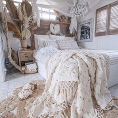 a bedroom with a bed covered in blankets and rugs on top of the floor