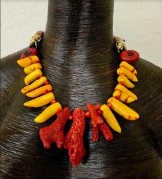 Raw and rough red branch corals are the focal point in this lightweight and comfortable statement necklace for either men or women. Each coral is spaced with a tiny red coral. Vibrant and hot orange corals comprise the bulk of the necklace with red coral oval beads separating the front fromt he back. Funky artisan hand painted glass tube beads from Africa complete the back. Adjusts from 18-21" with gold tone hardware, a tiny lobster claw clasp and a 3" extender chain complete the piece. OOAK Wea Luxury Red Coral Gemstone Necklace, Unique Orange Red Coral Necklace, Unique Handmade Coral Necklace, Exotic Dramatic, Orange Branch, Glamorous Women, Orange Statement Necklace, Art Statement, Hot Orange