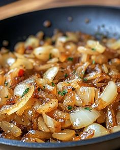 onions are being cooked in a frying pan