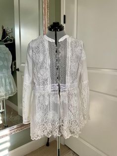 This short lace duster is made with vintage fabrics from various items carefully selected to make a delicate duster. It has long sleeves. It has two layers of lace at the bottom, which gives it a flow effect. It's cream and white lace has been put together to give it a feminine flow feel, it can be a great addition to wear over a tank or a T-shirt or a blouse over jeans or a dress.It is a medium size. Lace Duster, Prescott Az, Feel It, Vintage Fabrics, Vintage Lace, Lace Shorts, Medium Size, White Lace, The Selection