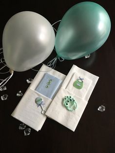 balloons, napkins and other items are sitting on a table with some glass beads