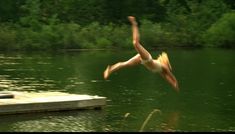 a person jumping into the water from a dock