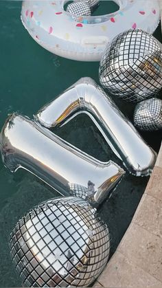 inflatable balls are floating on the water