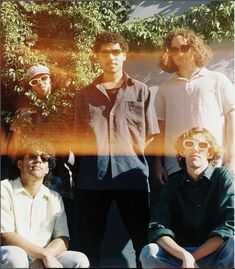 a group of young men sitting next to each other