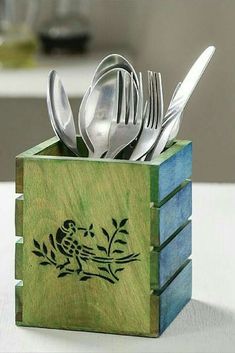 a wooden box with spoons and forks in it