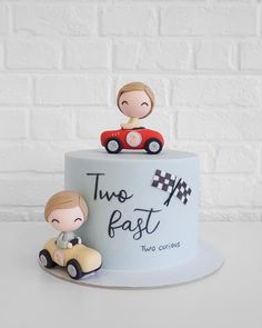 a cake decorated with two people driving a car and the words two fast on it