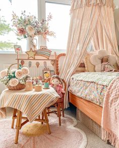 a child's bedroom decorated in pink and white with flowers on the bed, teddy bear sitting at table