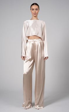 Our Paris Pant is a high-waisted, wide-leg pant made from 100% polyester. Simple, yet elegant the silky look elevates the overall appearance of the pant. The small touches such as pleats and the front zipper closure make them all the more unique. Neutral Elegant Outfit, Satin Set Outfit, Silk Pants Outfit, Pisces Style, Neutral Wardrobe, Baddie Vibes, Silky Pants, Silk Wide Leg Pants, Soft Dramatic