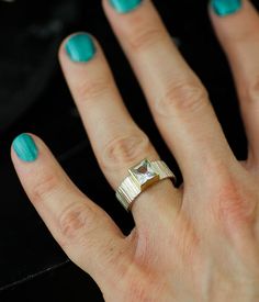 Part of my Forest Floor series, this bold ring evokes cold, crisp days and the smell of wood and leaves.

Elements of the natural world are deconstructed and conveyed in lines, texture, and color; the finished product features a clean and clear white topaz, secured by a 14K yellow gold bezel and presented on a hand-textured, sterling silver band.

IMPORTANT: This is a ready-to-ship piece—NOT made to order—available in size 7.25 only.

Not your size? Most rings can be easily resized by a reputable jeweler.

A customizable version of this ring is available here: Black Or White Square Fallen Branches Lines Texture, Neutral Jewelry, Wedding Pendant, Bold Rings, Forest Floor, Eco Friendly Jewelry, White Square, Wedding Art, Clear White