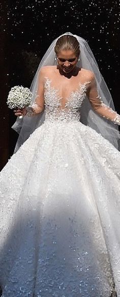 a black and white photo of a woman in a wedding dress