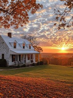 a white house sitting on top of a lush green field