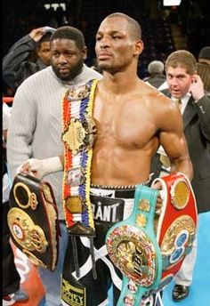 two men standing next to each other holding belts