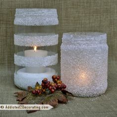 two white candles sitting next to each other