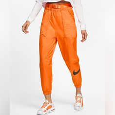 Modern, Street-Ready Style. Featuring Bold A Swoosh Graphic And Ripstop Woven Material, The Nike Sportswear Swoosh Pants Give You Lightweight Comfort And Modern, Street-Ready Style. A Paneled Design With Ripstop Pockets. Nike Streetwear Pants For Spring, Orange Sportswear Bottoms For Sports, Orange Athleisure Pants For Sports, Spring Athleisure Orange Bottoms, Orange Bottoms For Spring Streetwear, Sporty Orange Pants For Streetwear, Casual Orange Sports Pants, Orange Sports Bottoms For Spring, Sporty Orange Bottoms For Streetwear