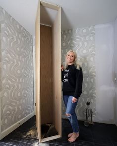 a woman standing next to a wooden box