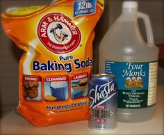 two bottles of baking soda and a canister of flour soap on a counter top