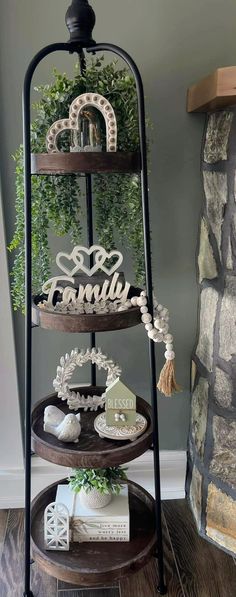 a three tiered shelf with family signs on it