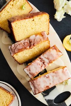 slices of lemon cake sitting on top of a white plate next to sliced oranges